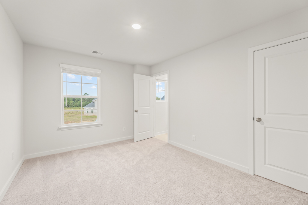 A room with white doors and a window.