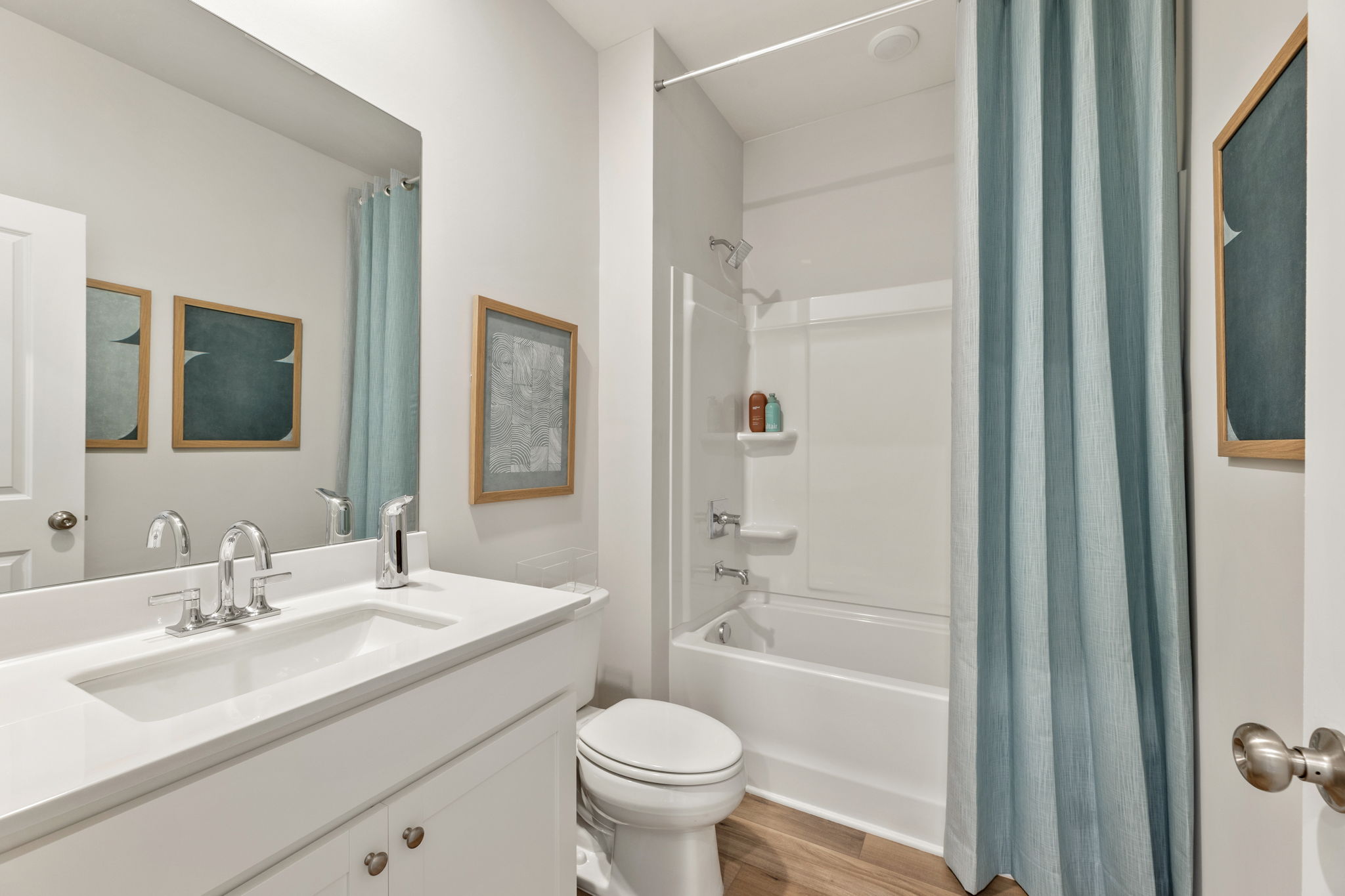 A bathroom with a sink toilet and shower.