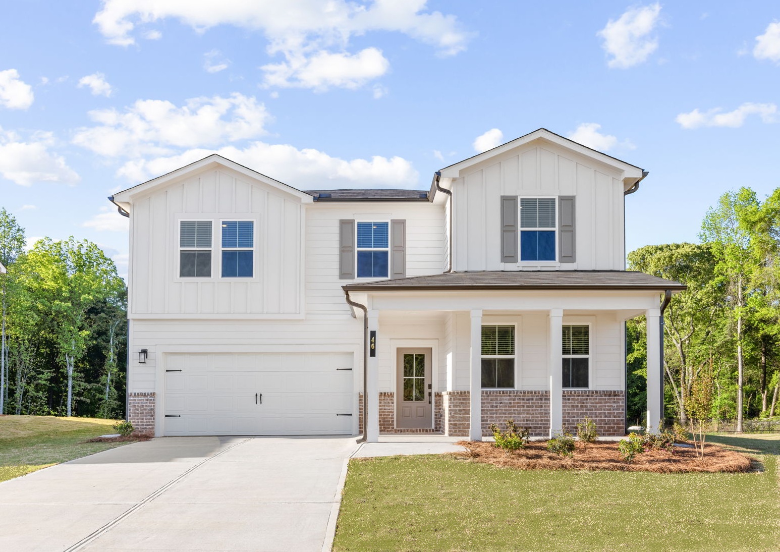 A white house with a driveway.