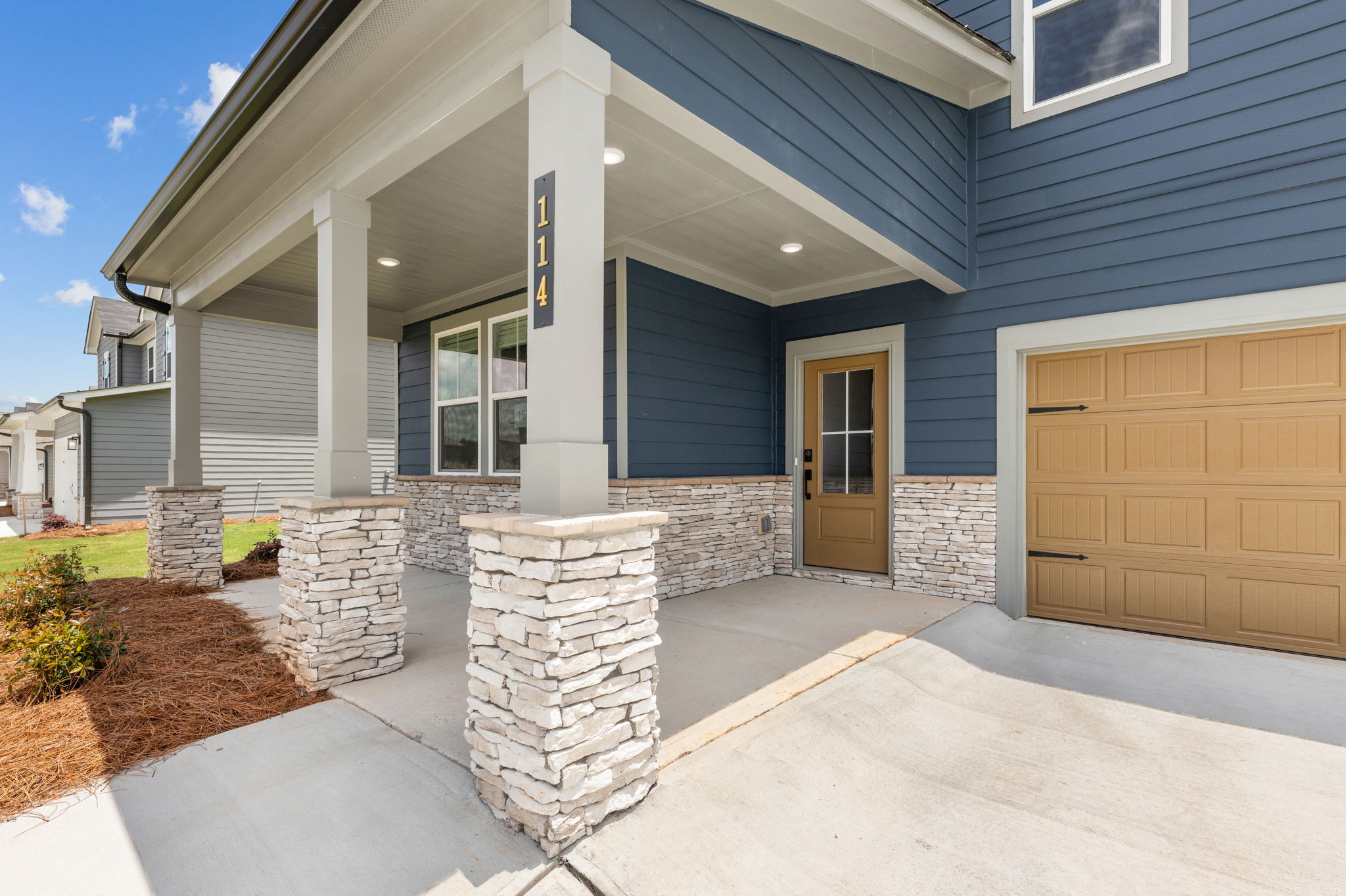 A house with a stone driveway.