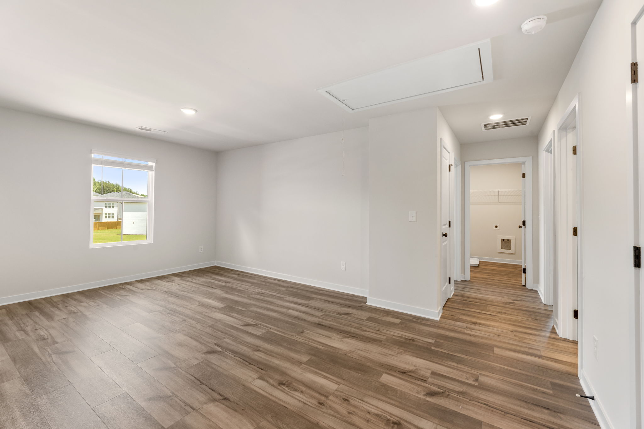 A room with white walls and a wood floor.