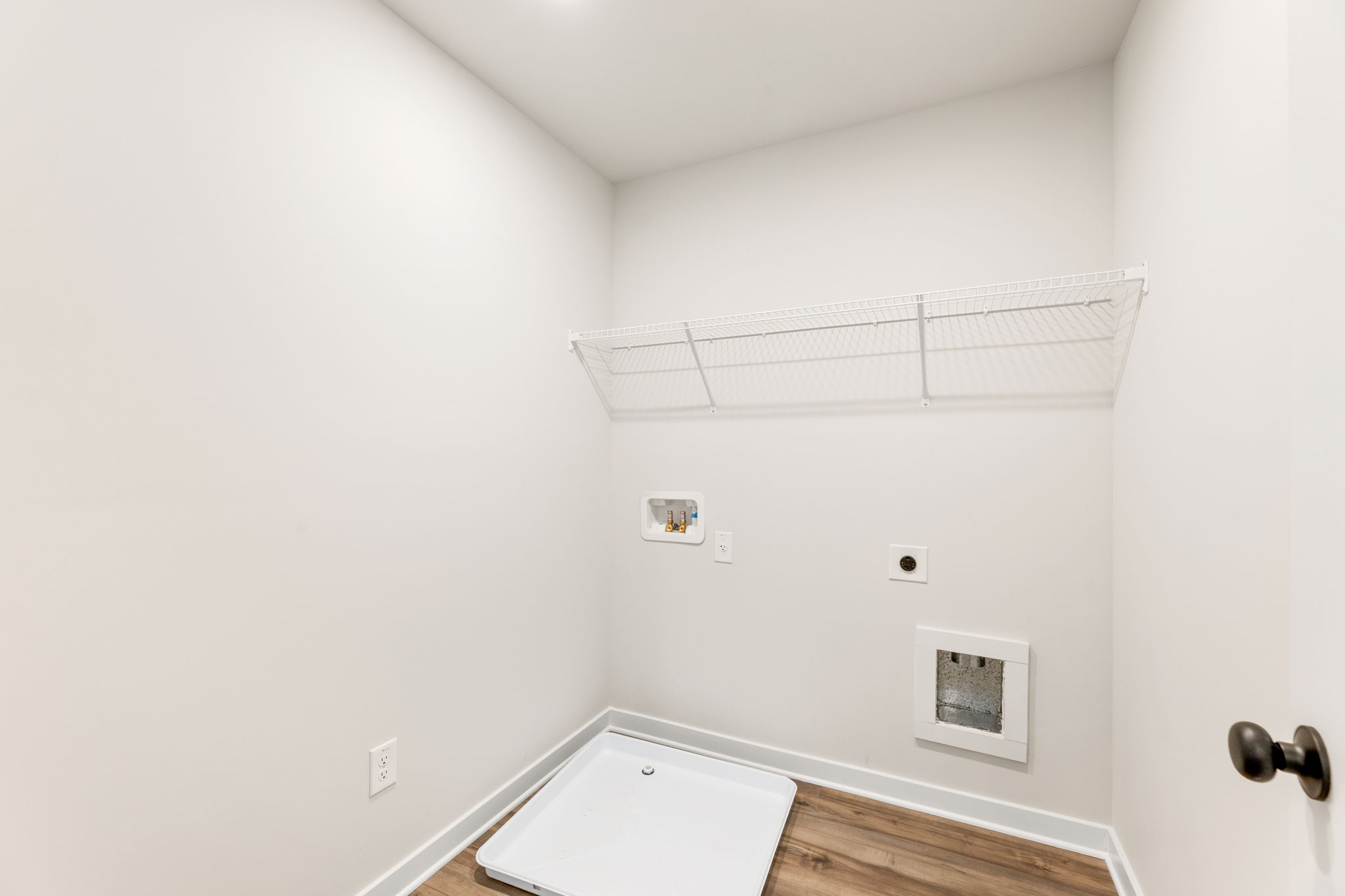 A white room with a white wall and a white door.