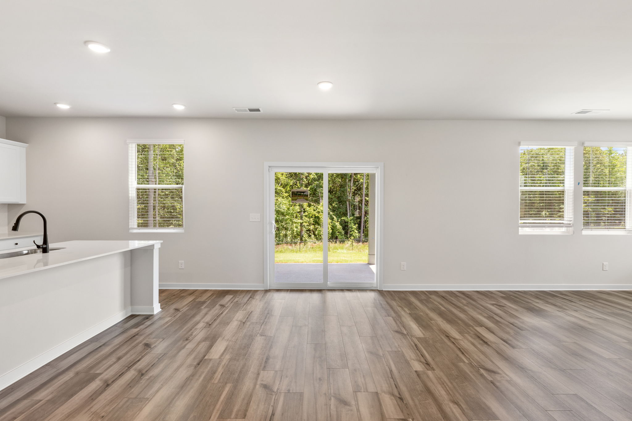 A room with a wood floor and a window with a wood floor.