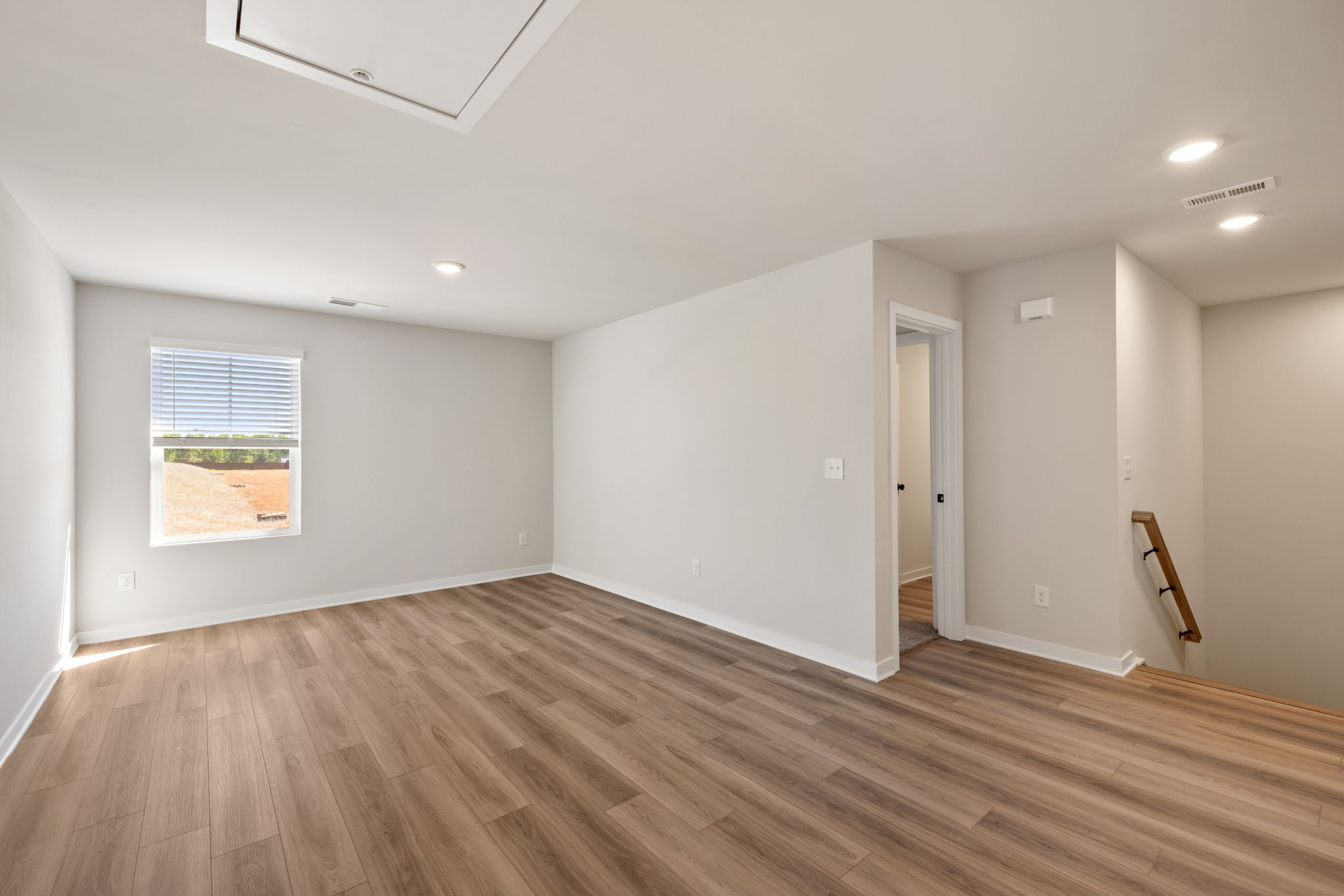 A room with a wood floor and a wood floor.