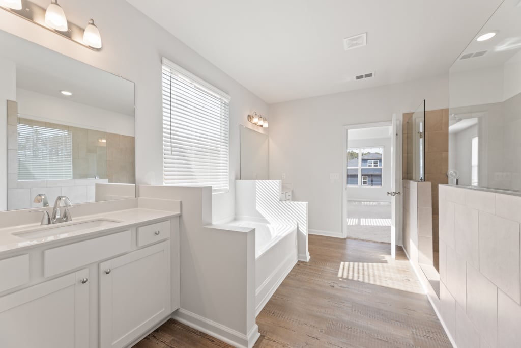 A bathroom with white cabinets.
