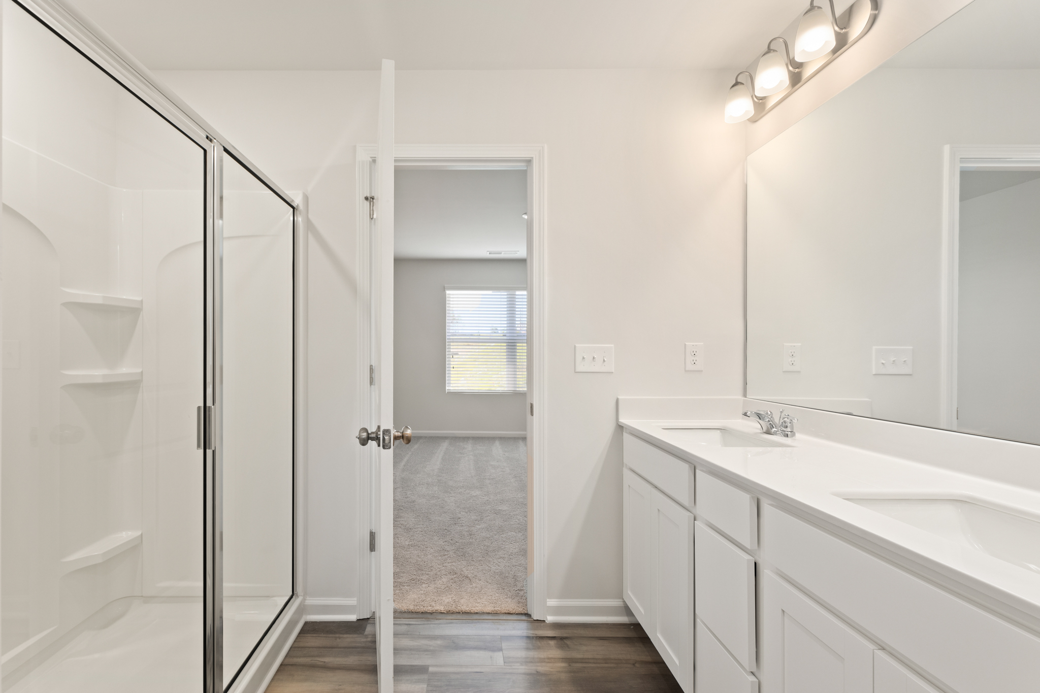 A bathroom with a shower unit and sink.