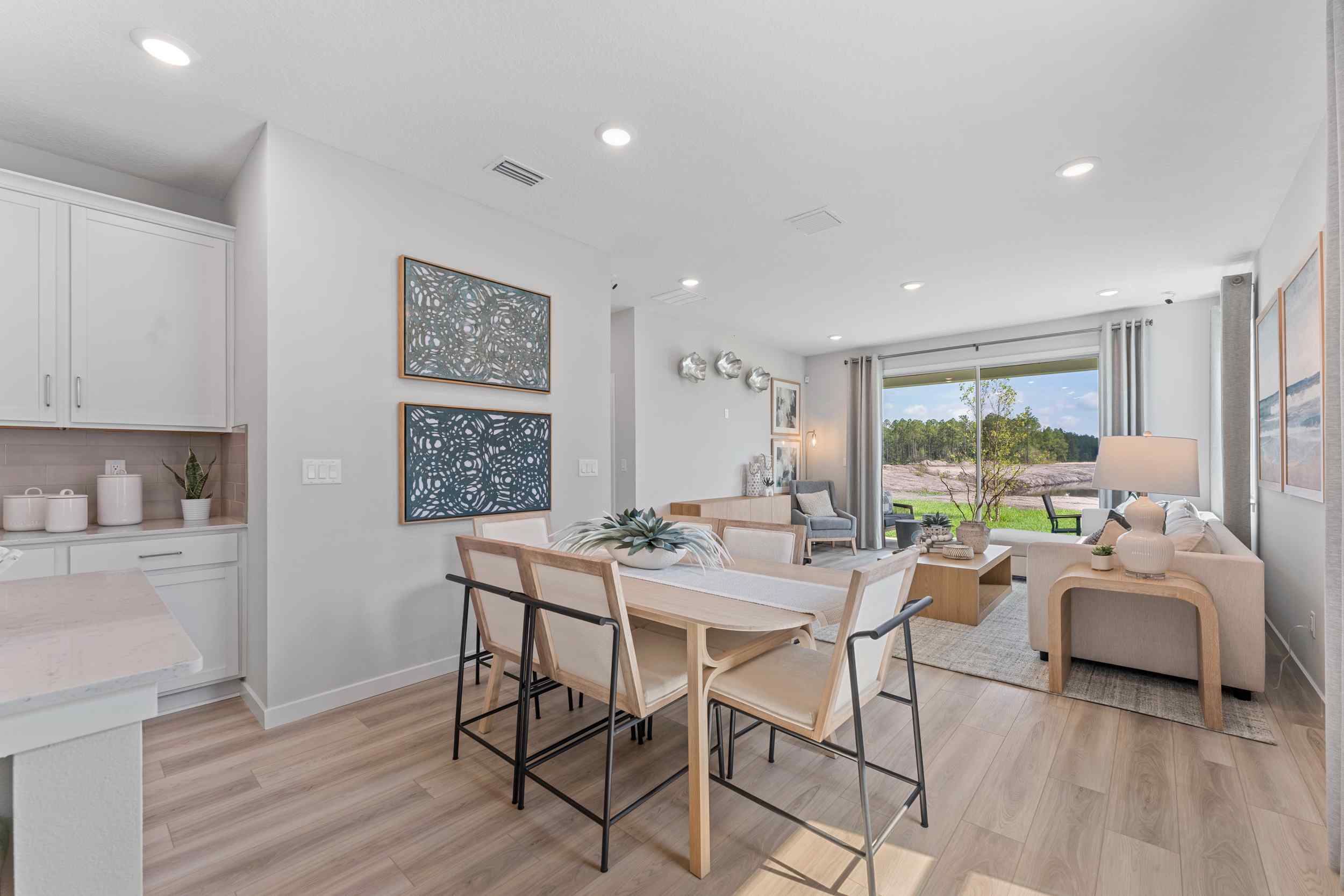 Laurel II Model Home Dining Area with Wood Table and Six Chairs  at Camden Woods in Kingsland, GA