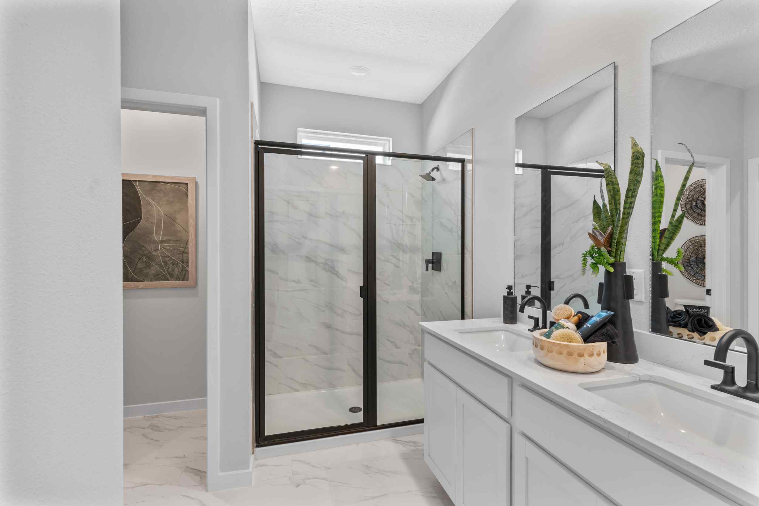 Silverbell II Model Home Primary Bath with Dual Vanity Sinks and Glass Shower at Camden Woods in Kingsland, GA