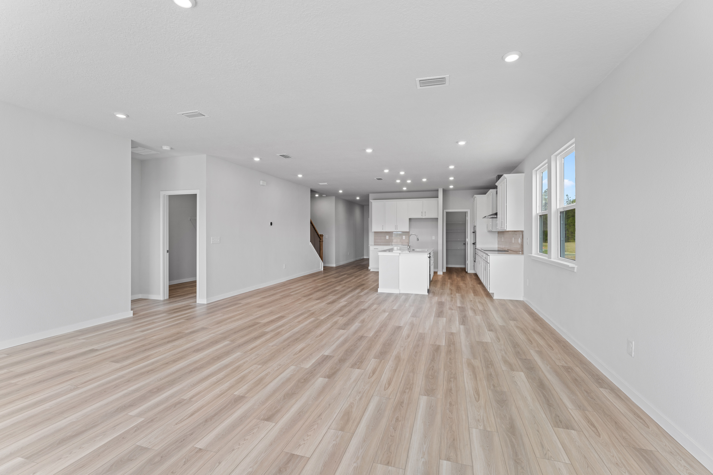 Lot 595 Living Area with View of Kitchen and Open Stair rail at NorthShore