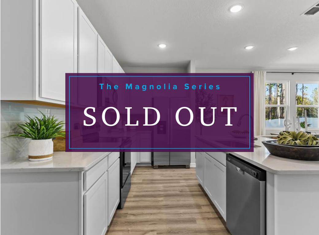 A kitchen with white cabinets and a purple sign.