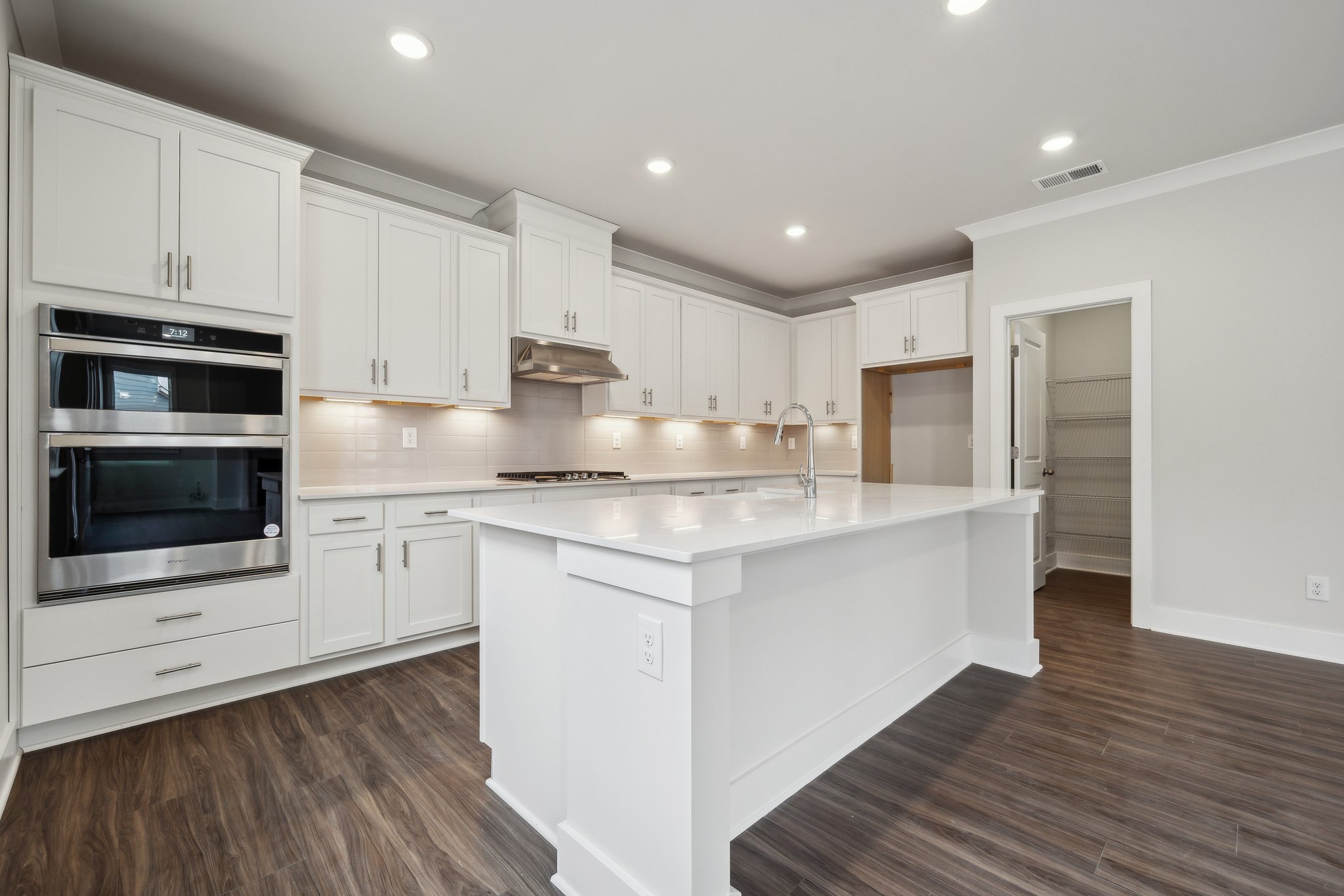 A kitchen with white cabinets.