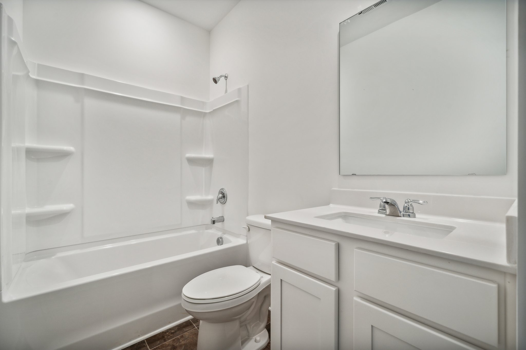 A bathroom with a tub sink and toilet.
