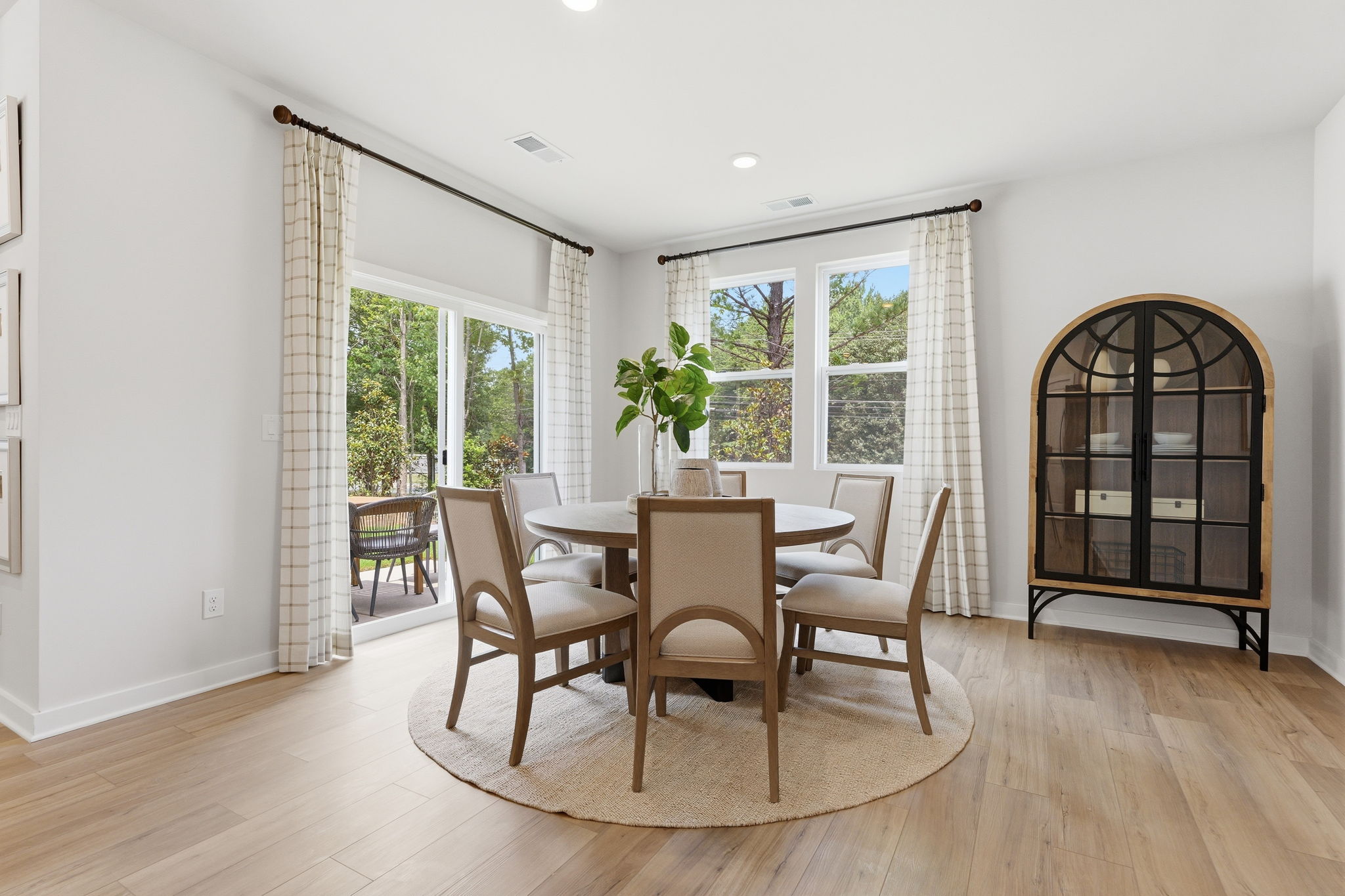A dining room table with chairs around it.