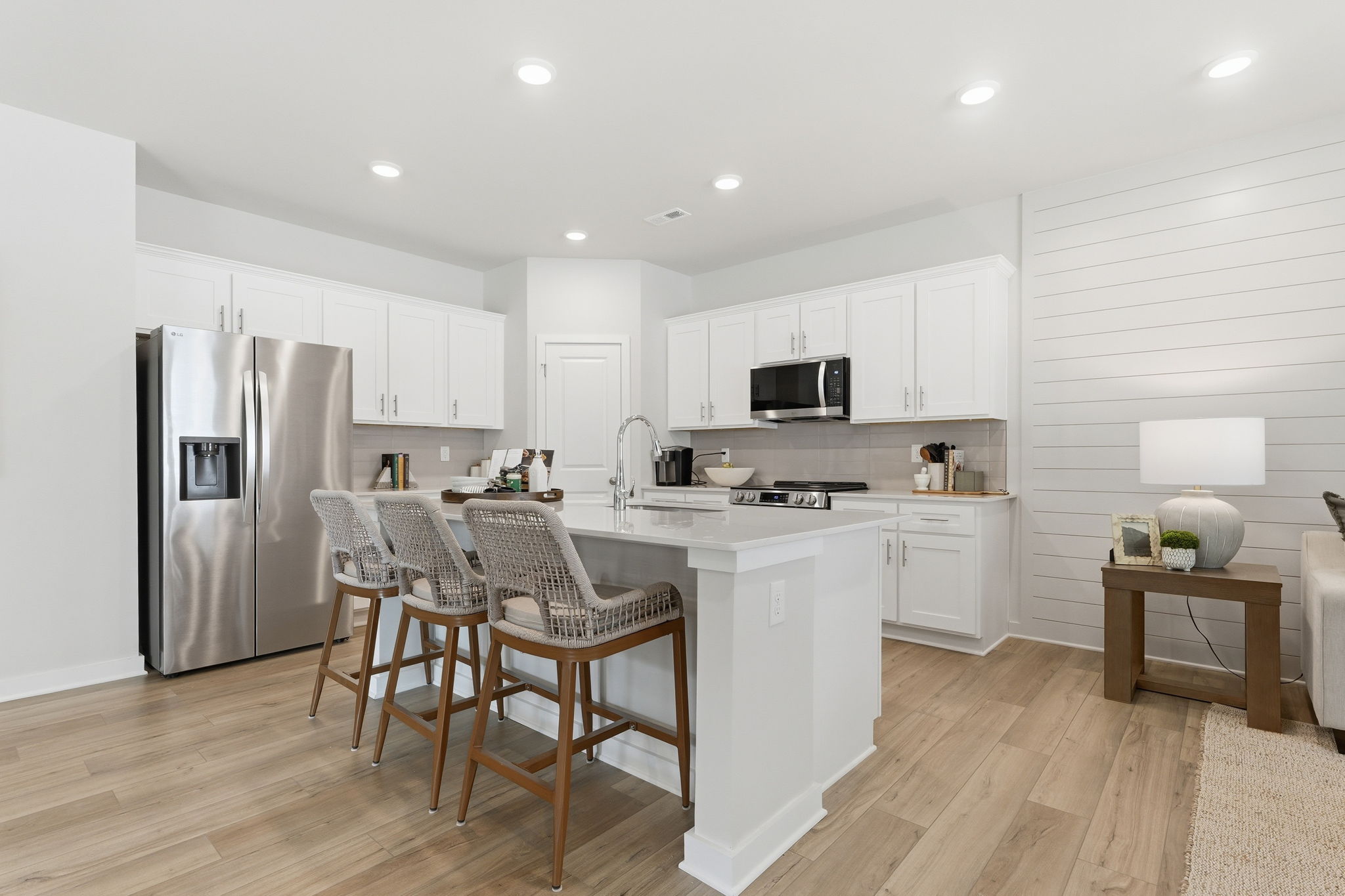 A kitchen with white cabinets.