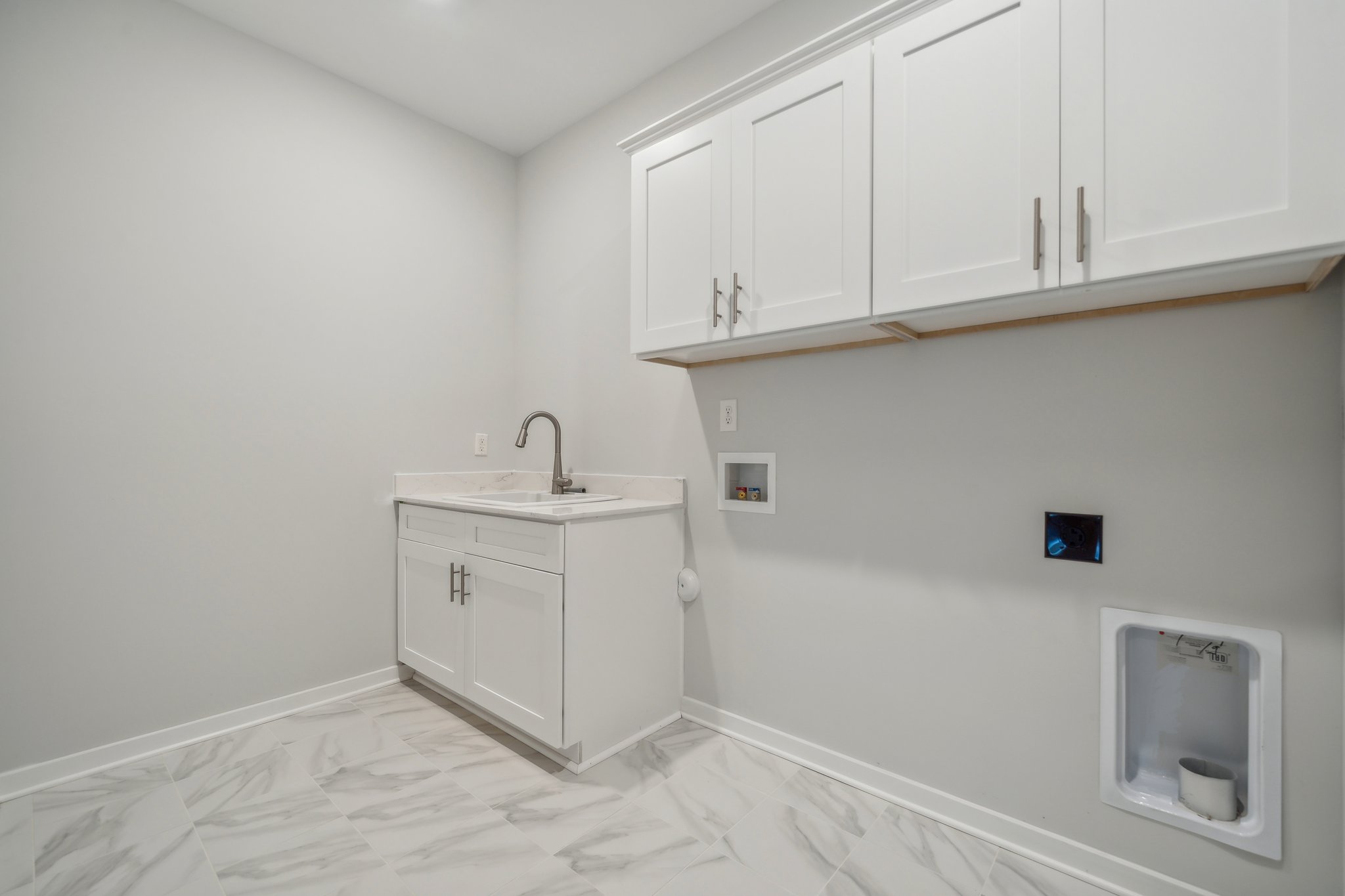 A white kitchen with white cabinets.