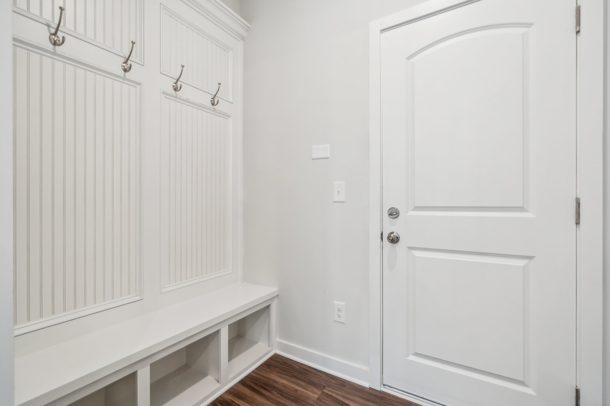 A white door with a white shelf.