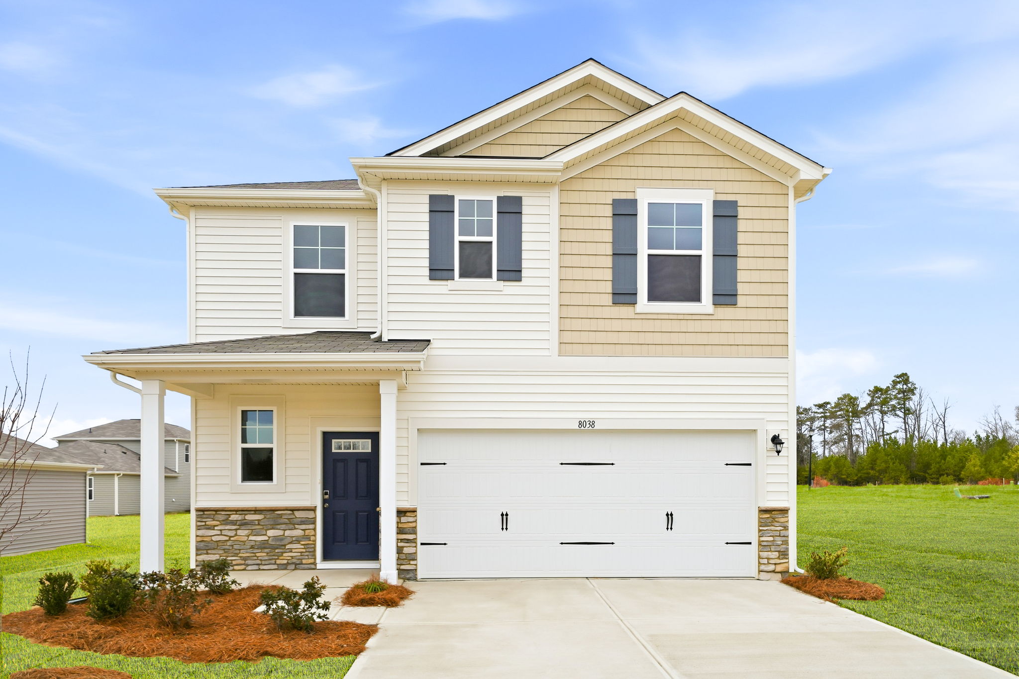 A white house with a driveway.
