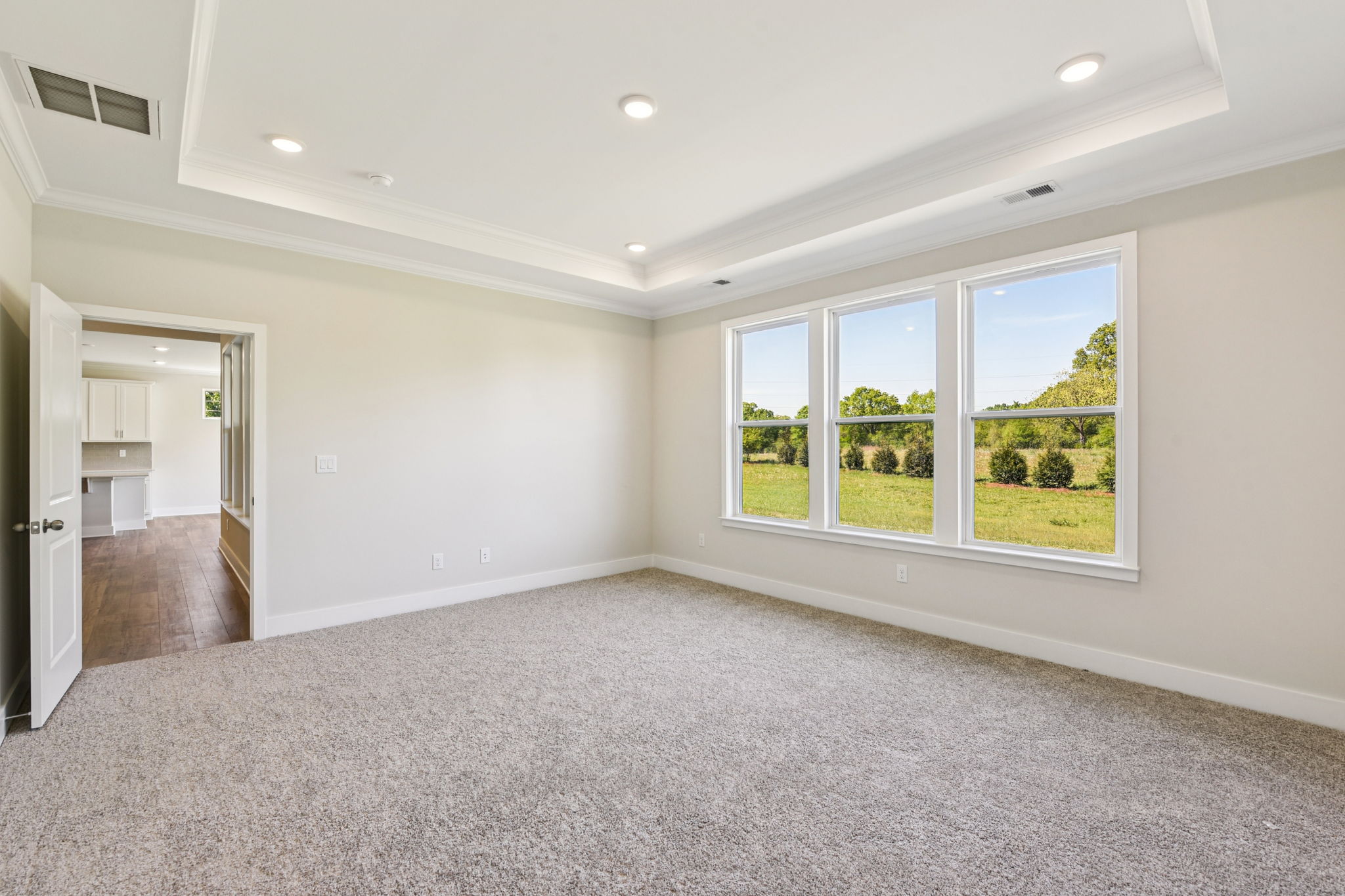 A room with a window and a carpet.