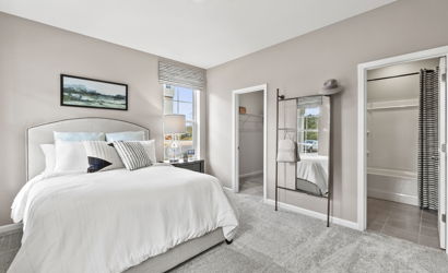 A bedroom with a large mirror.
