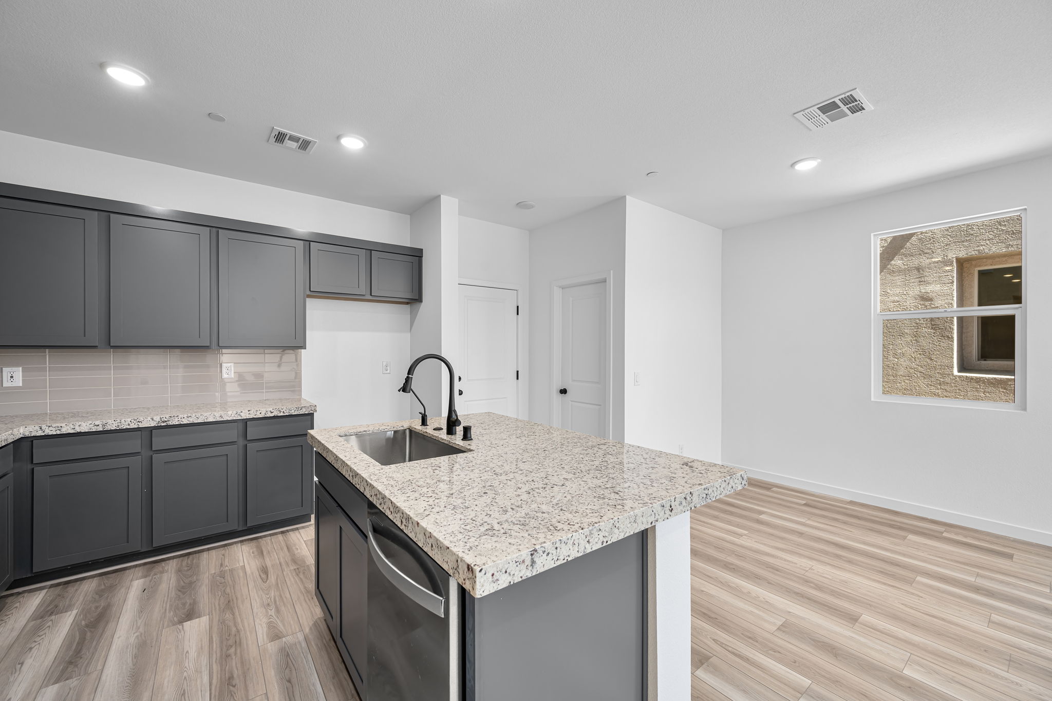 A kitchen with marble counters.