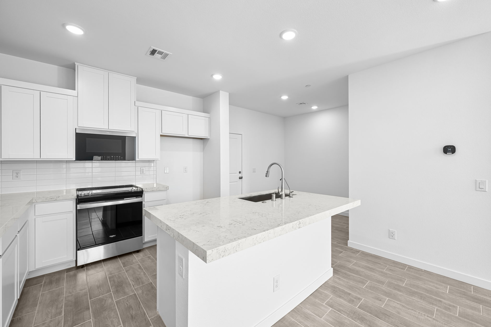 A kitchen with white cabinets.