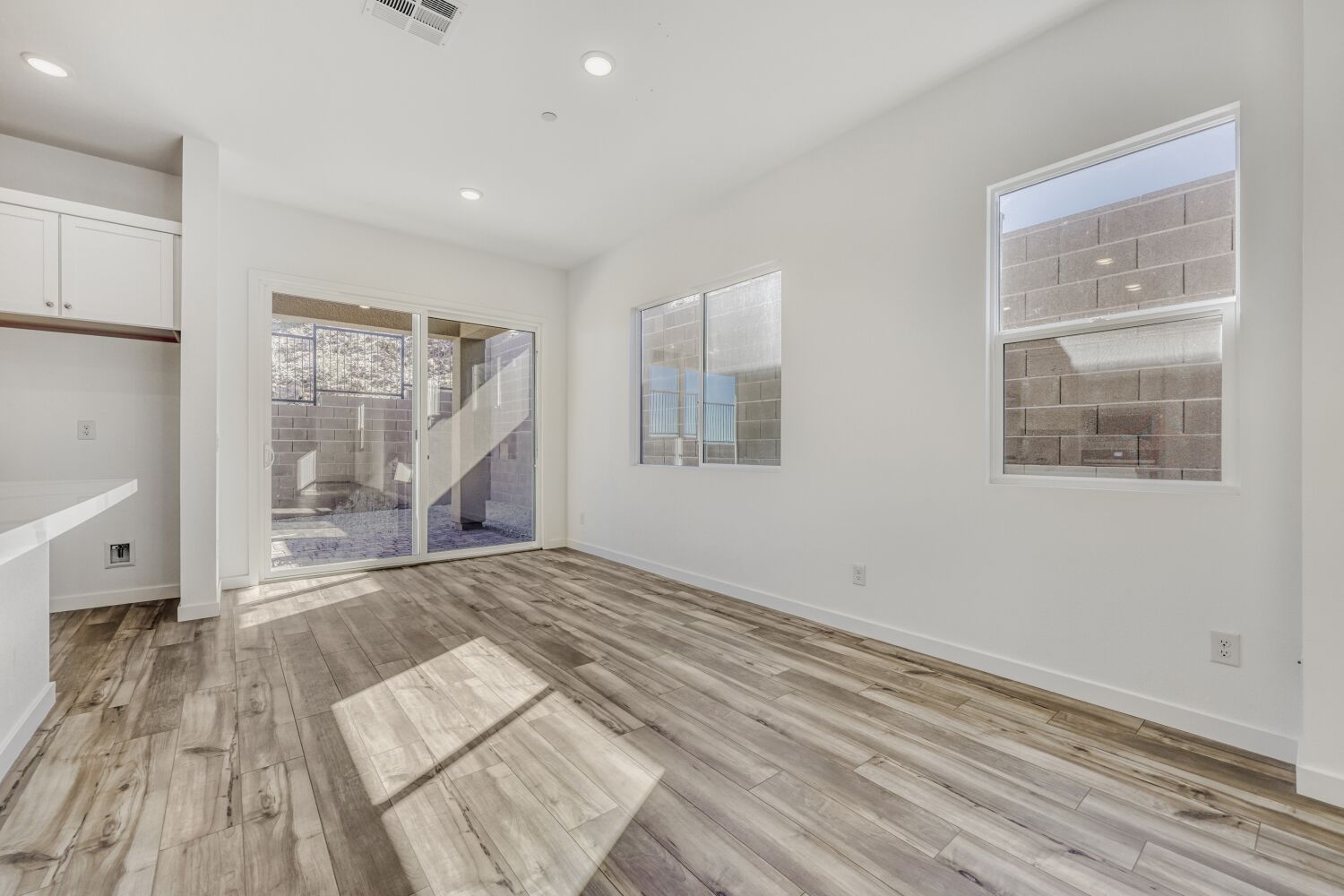 A room with a wood floor and a wood floor with a window.