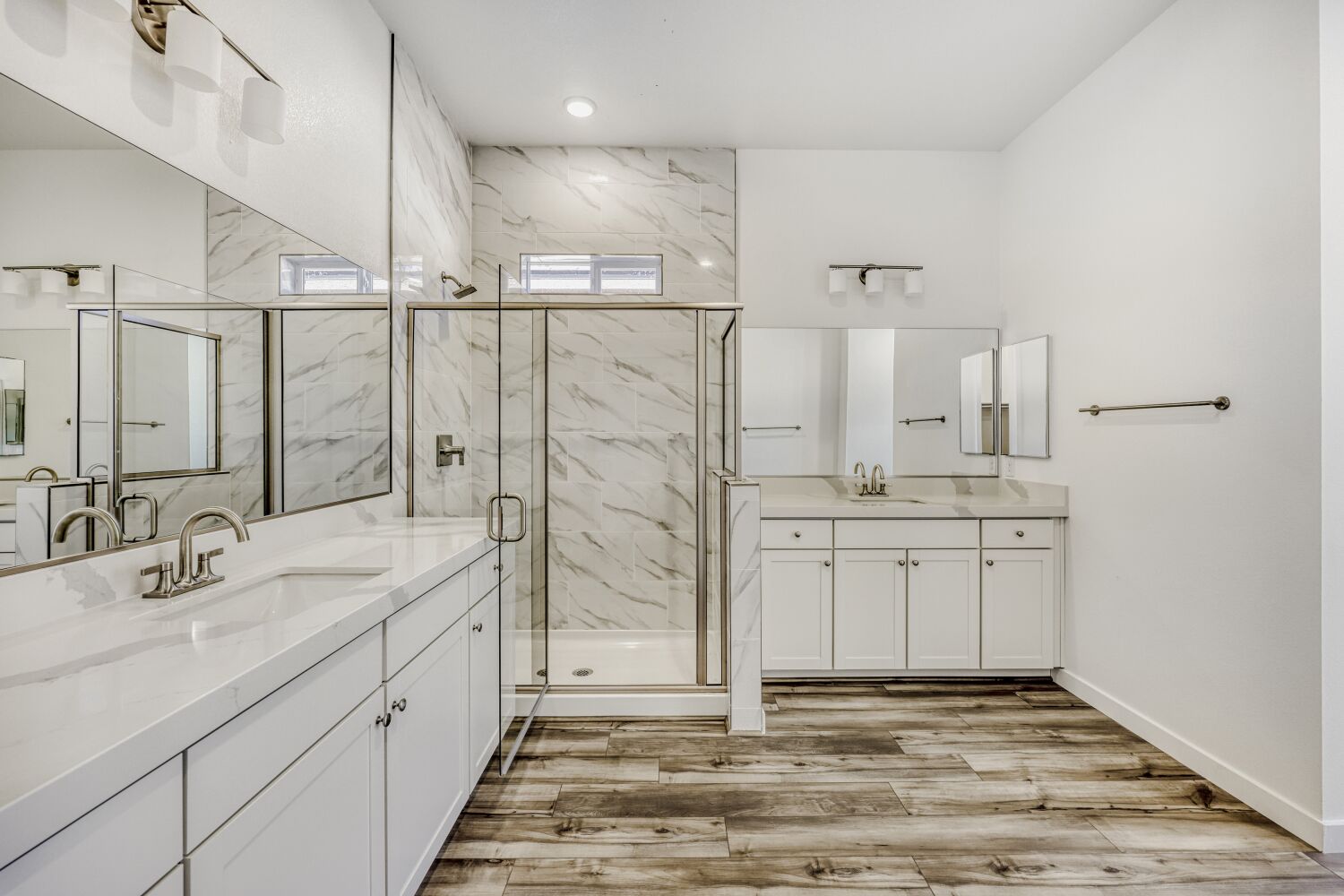 A bathroom with white cabinets.