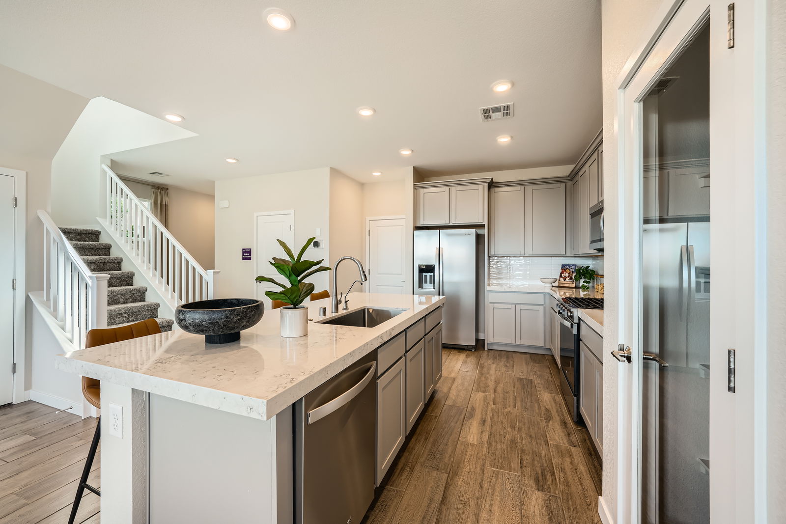 A kitchen with a marble island.