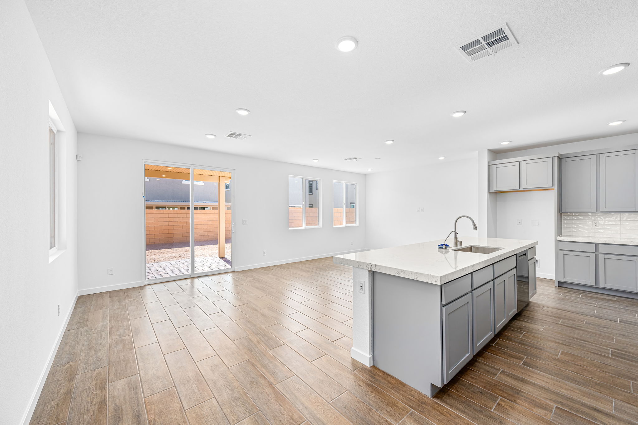 A kitchen with a wood floor.