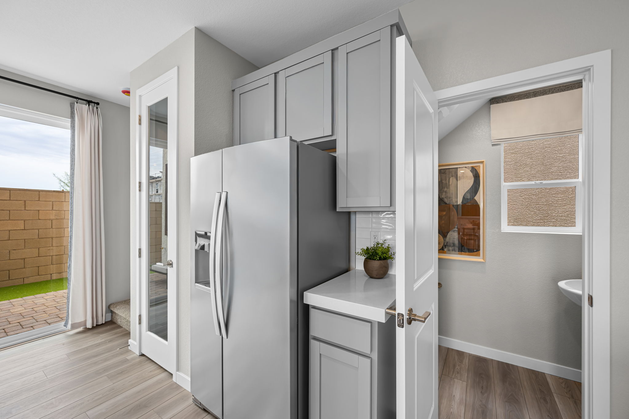 A kitchen with white cabinets.