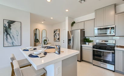 A kitchen with white cabinets.