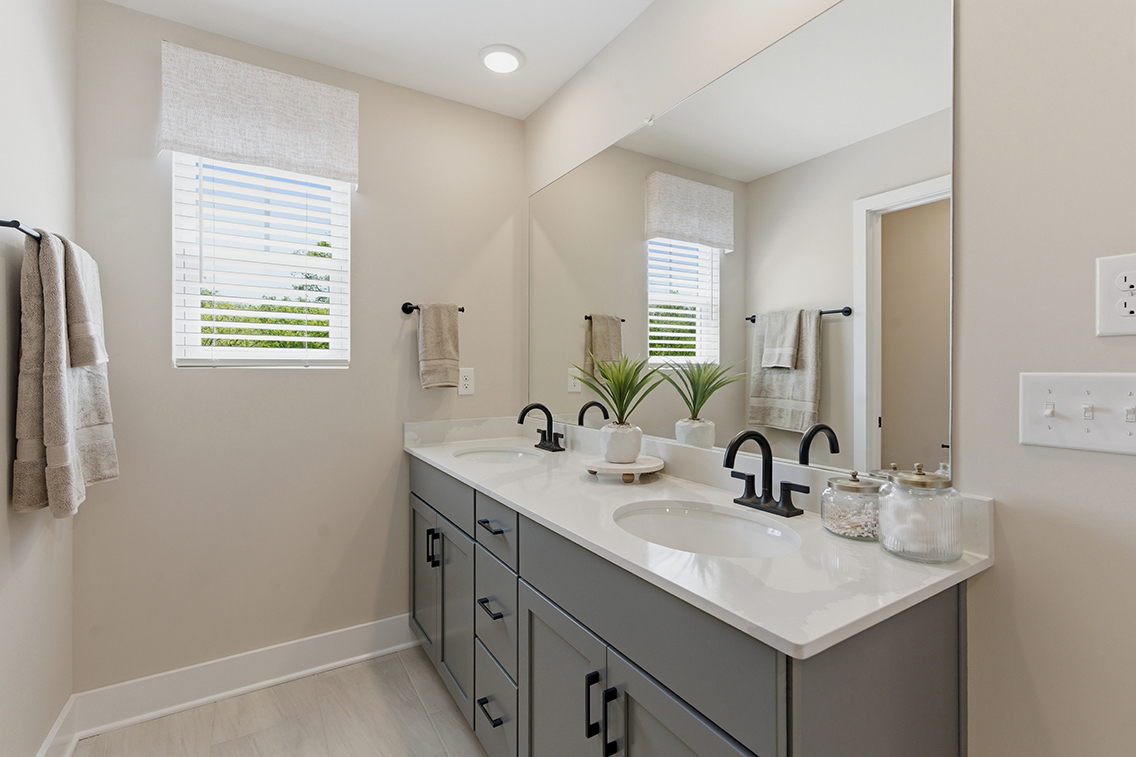 A bathroom with a sink and a mirror.