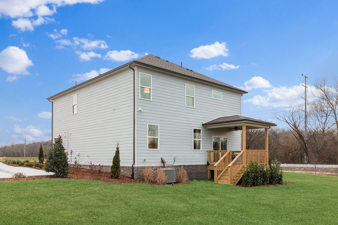 A house with a yard and a fence.