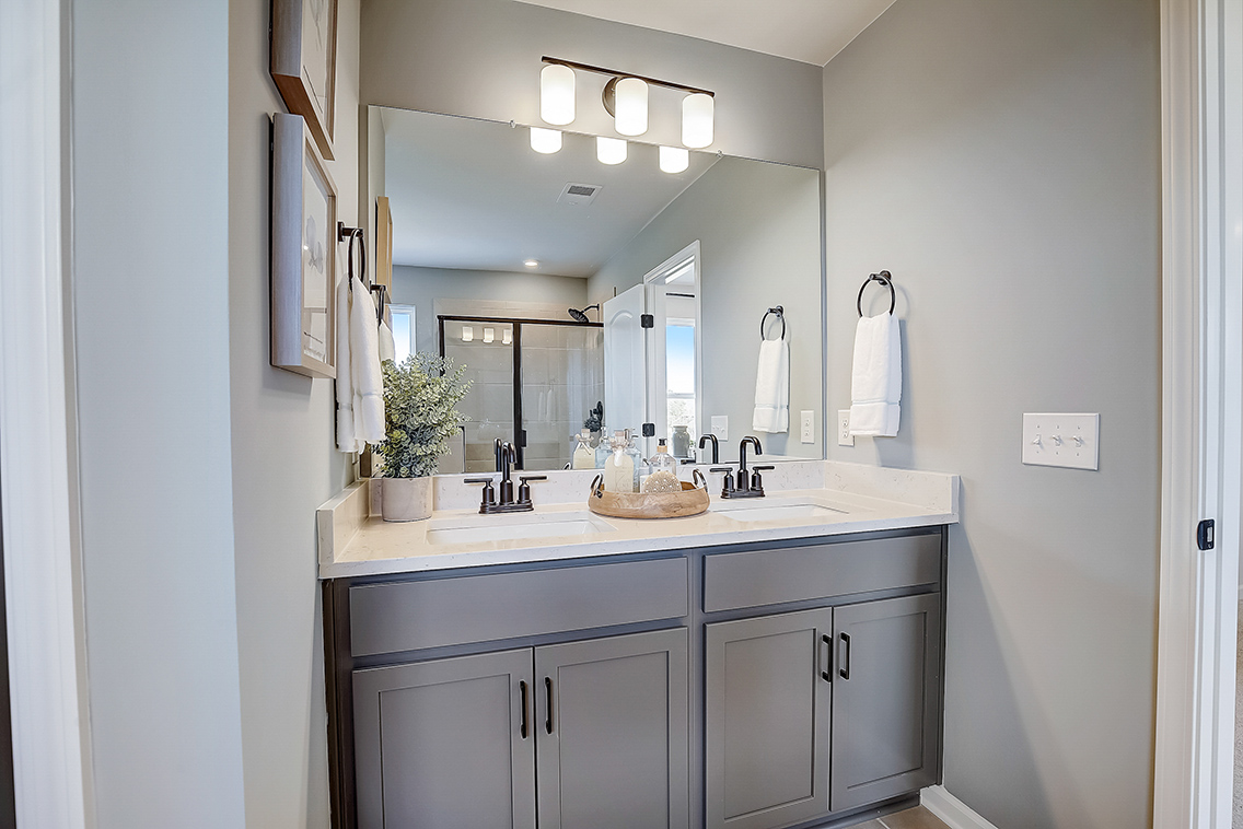 A bathroom with a large mirror.