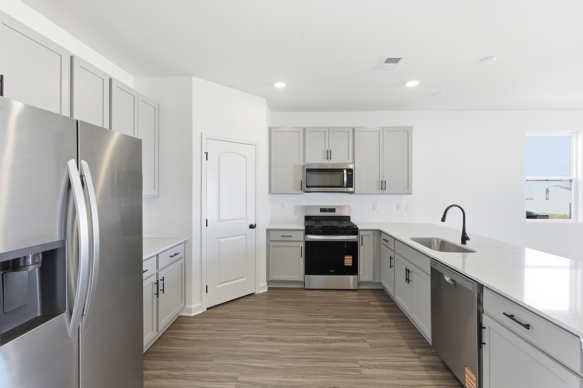 A kitchen with white cabinets.