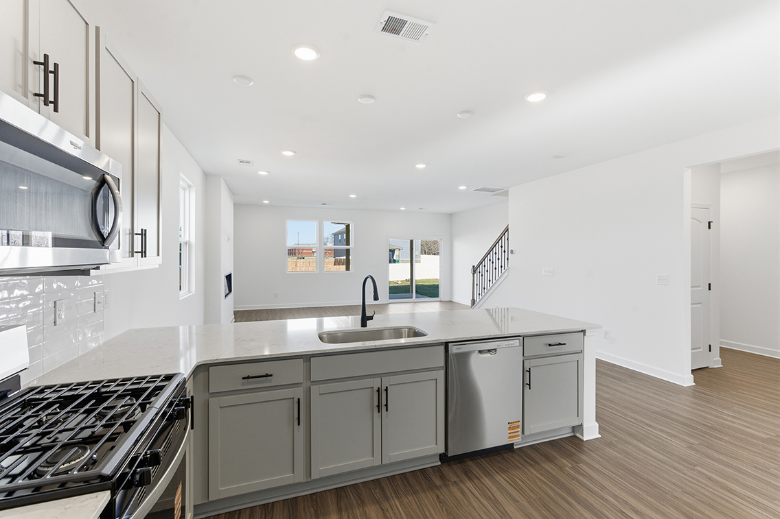 A kitchen with white cabinets.