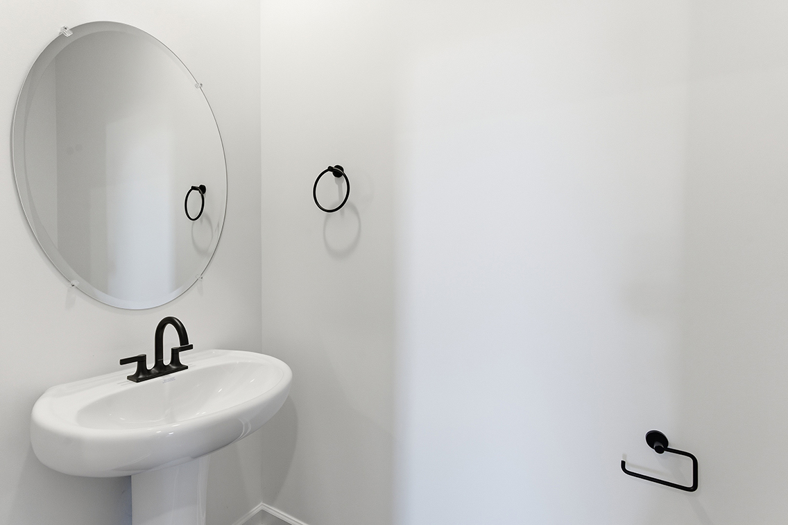 A bathroom with a mirror and a sink.