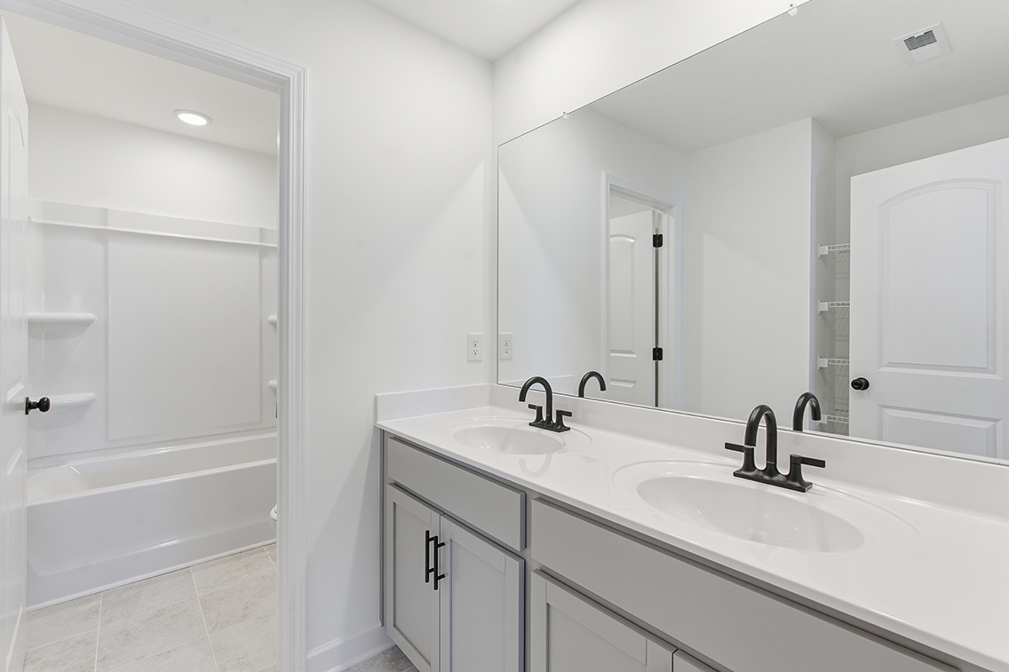 A bathroom with a sink and a mirror.
