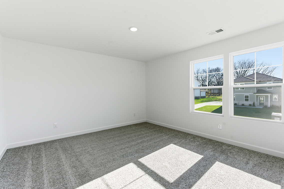 A room with a window and a tile floor.