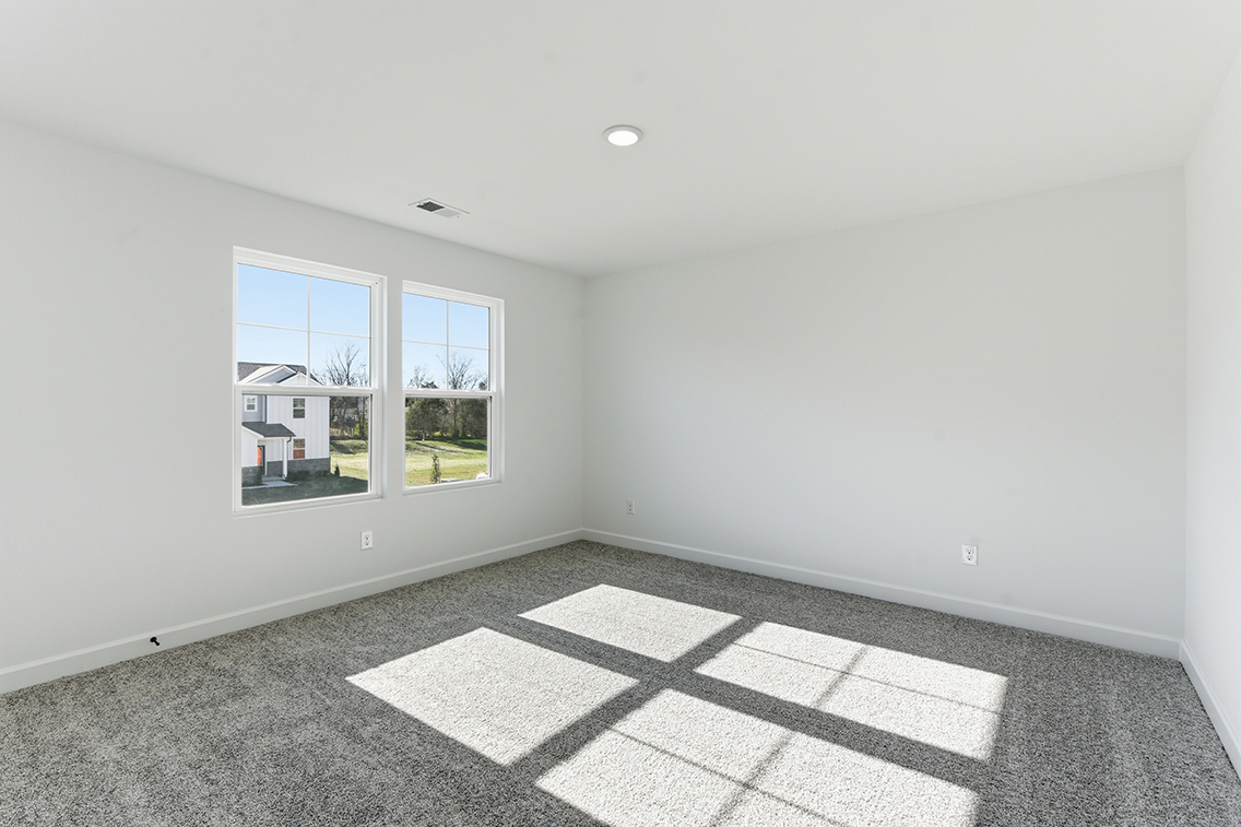 A room with a tile floor and windows.