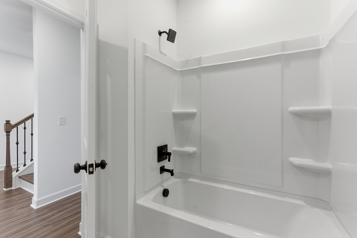 A bathroom with a bathtub and sink.