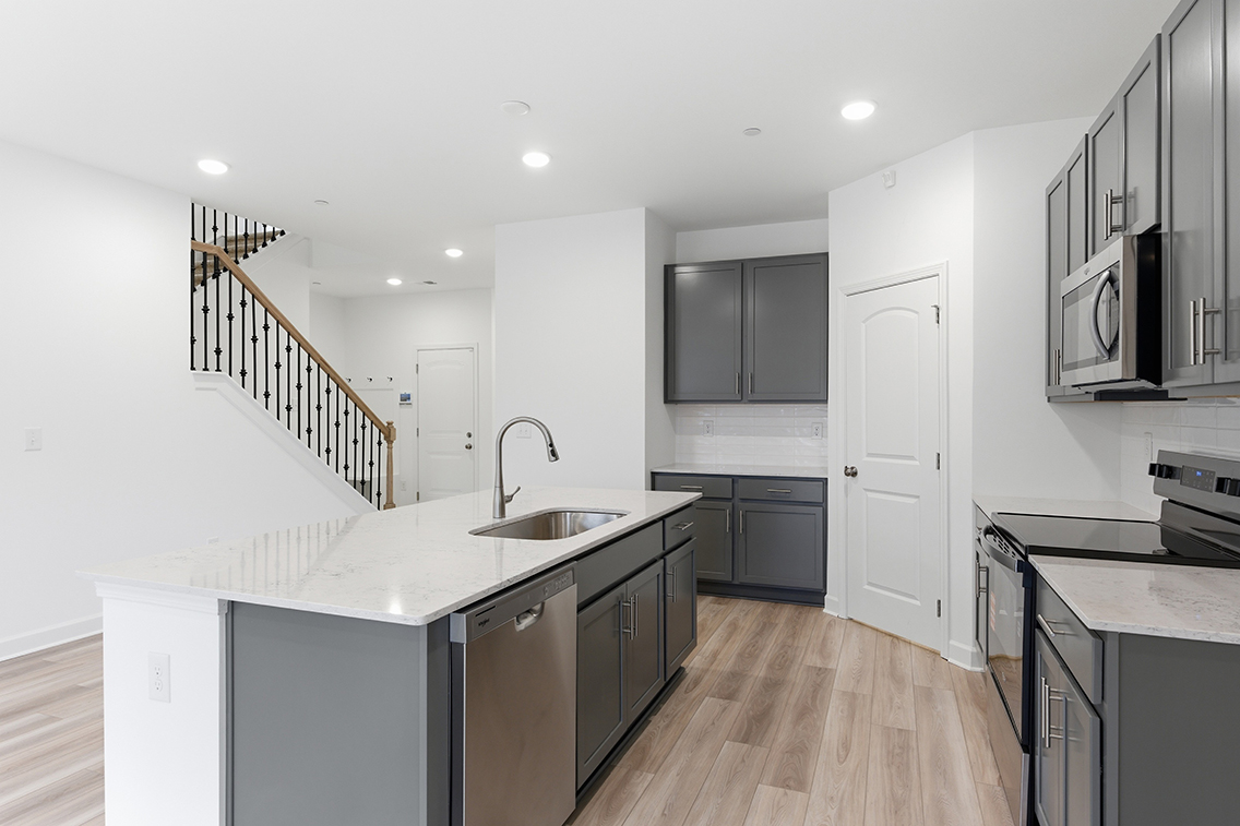 A kitchen with white cabinets.