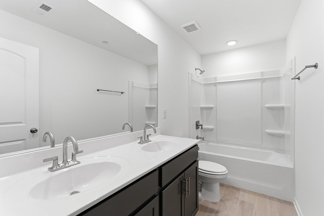 A bathroom with a tub sink and toilet.