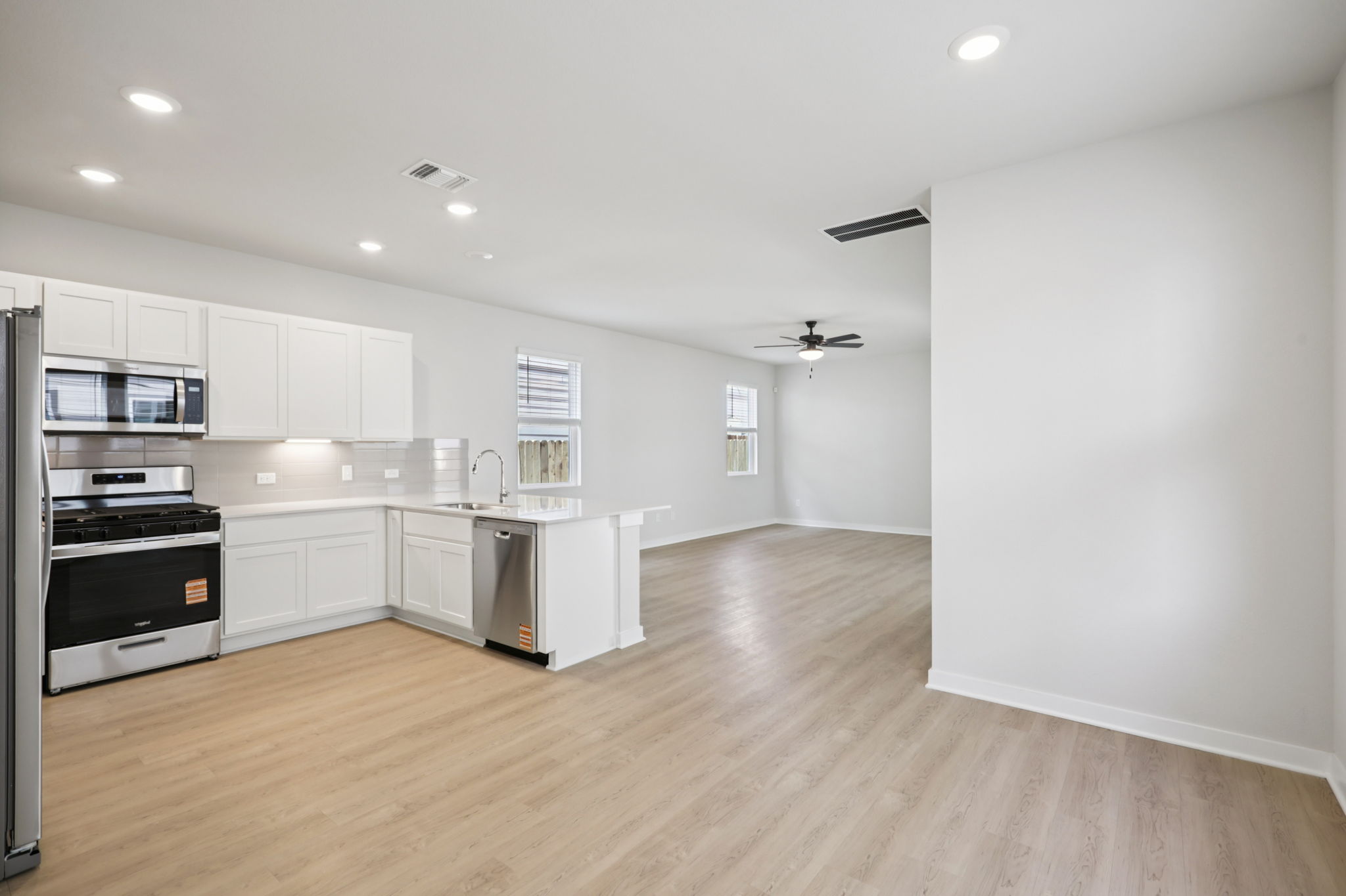 A kitchen with white cabinets.