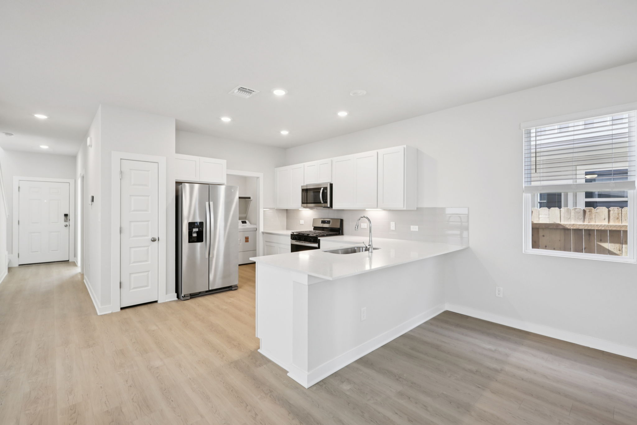 A kitchen with white cabinets.
