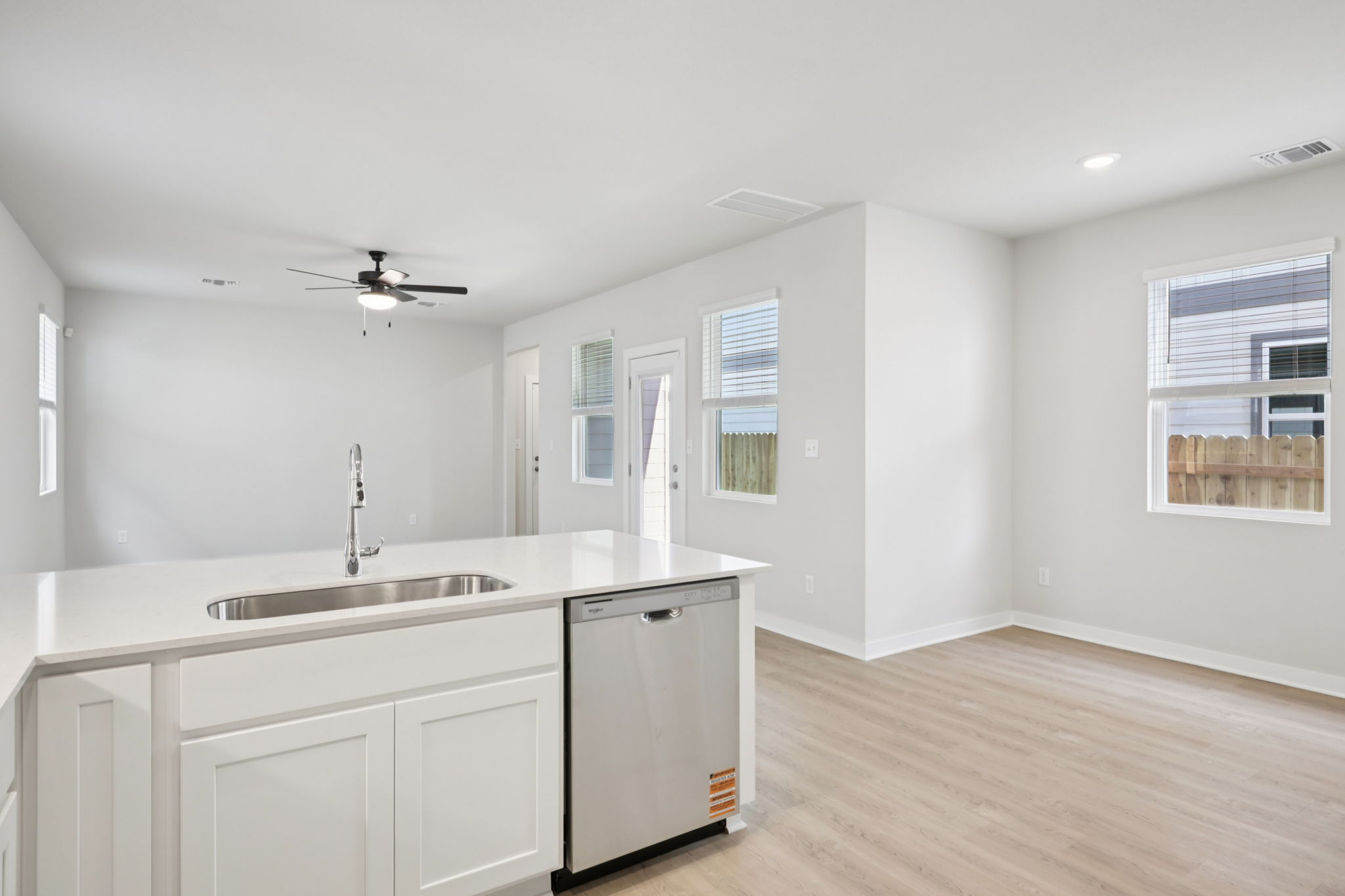 A kitchen with white cabinets.