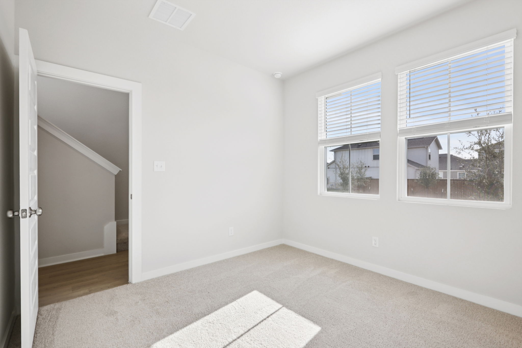 A room with a rug and a door.