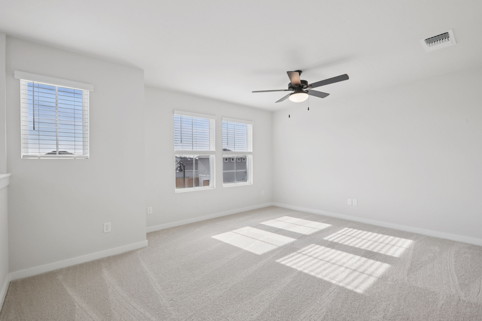 A room with a ceiling fan and a tile floor.