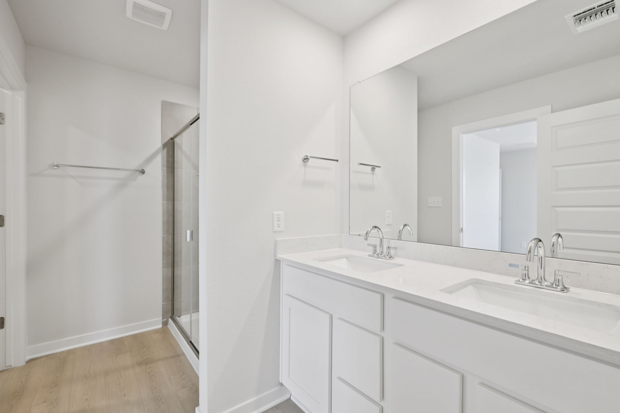 A bathroom with white cabinets.