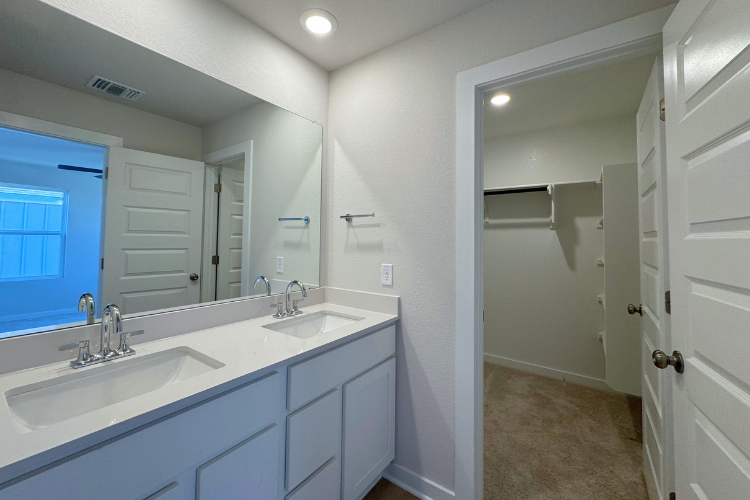 A bathroom with a large mirror.
